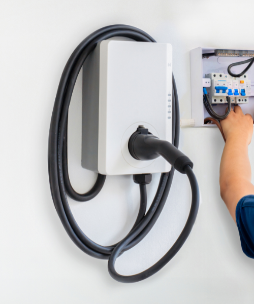 A person is plugging a device into a wall