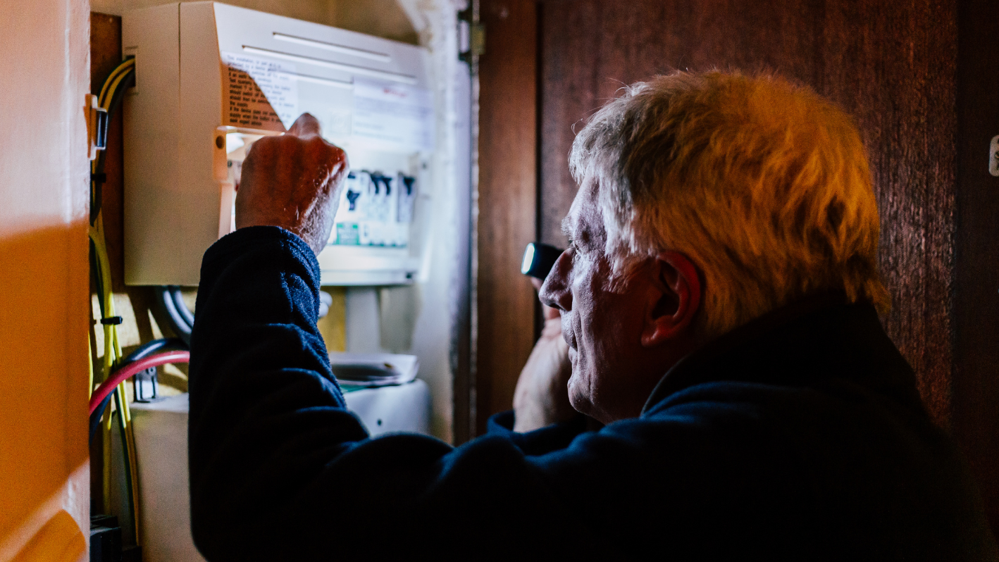 A man is looking at something on the wall